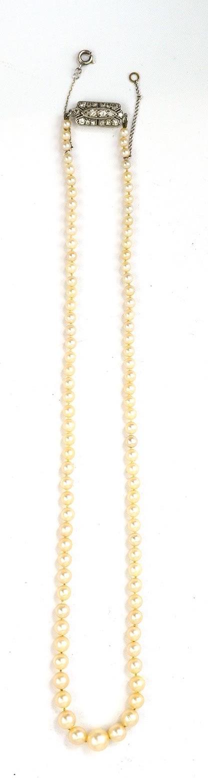 A single strand graduated cultured pearl necklace, with diamond cluster set white gold clasp